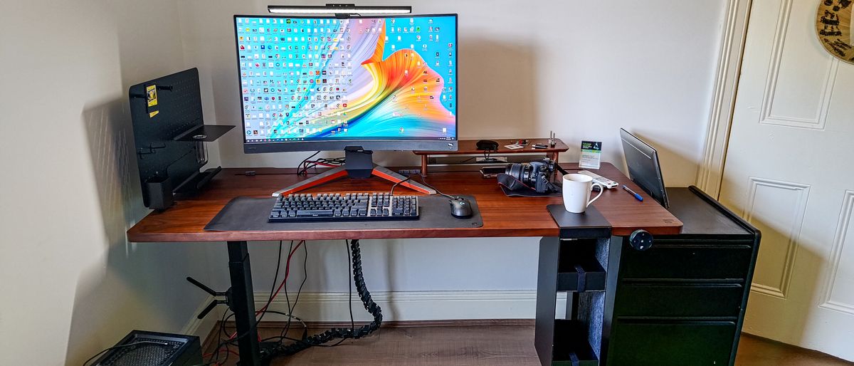 A monitor on its own stand placed with keyboard on the EverDesk Max