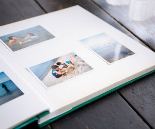 An open photo book with family pictures stuck in