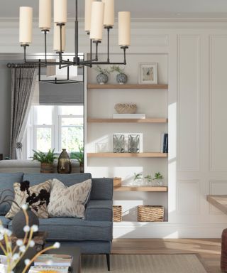 open plan kitchen living area with blue sofa, cream pendant light and built in shelving