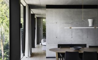 dining space against concrete wall at Canopy House