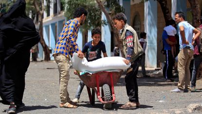 Yemenis receive humanitarian aid