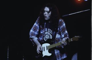 Rory Gallagher performs on stage in London, 1975