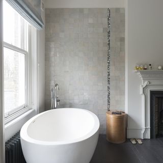 bathroom with white wall and bathtub