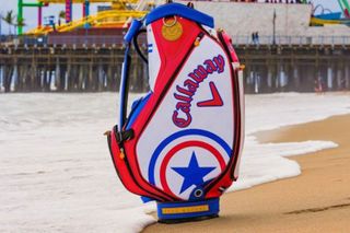 A Callaway golf bag in front of a pier