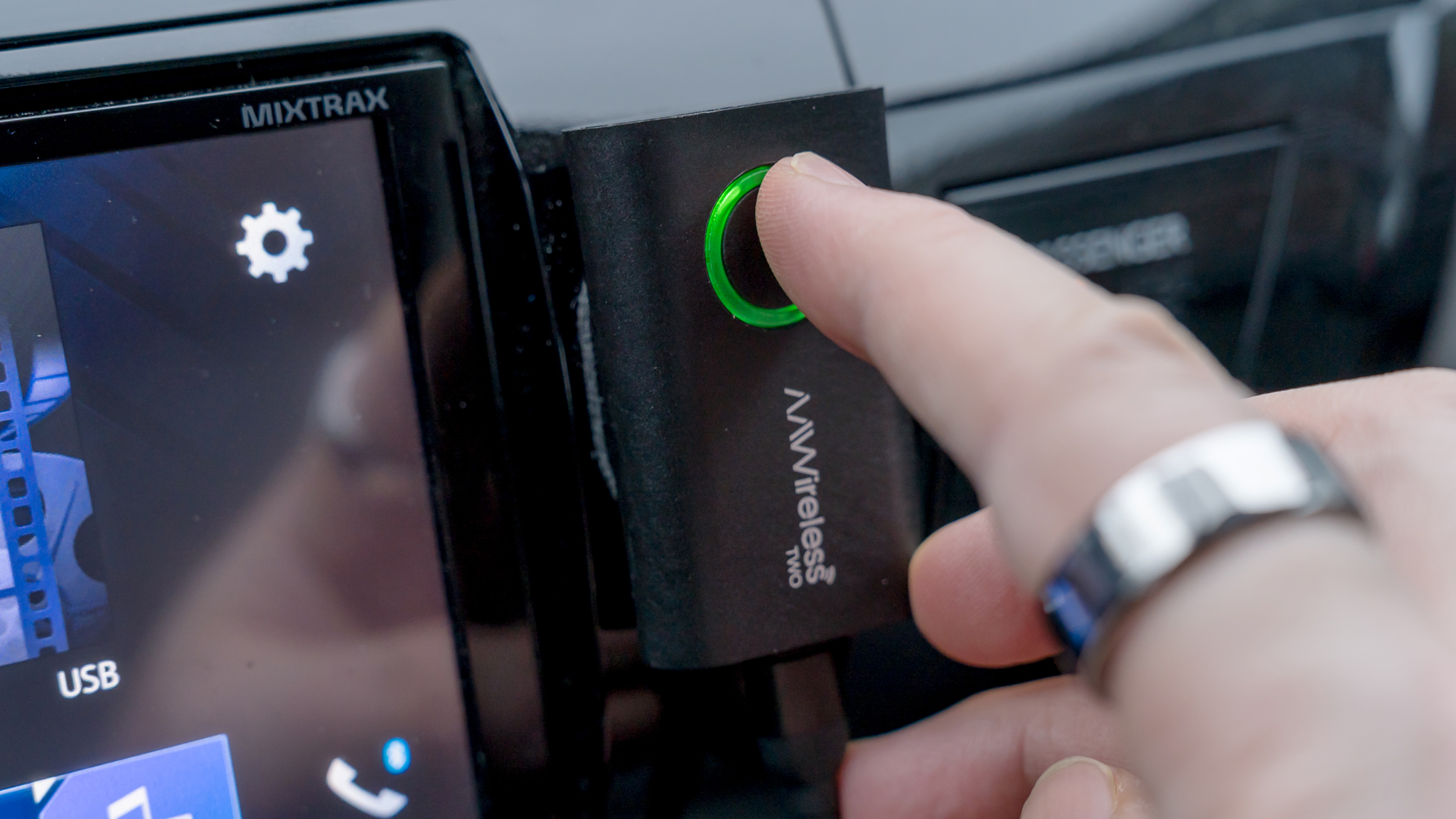 Pressing the button on the AAWIreless Two Android Auto dongle.