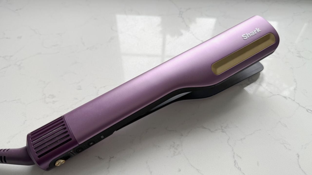 Side view of the Shark SilkiPro Straight in Plum Satin showing the full profile from ceramic plates to vented dryer base with purple swivel cord