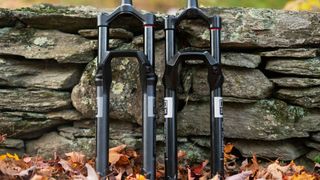 The new RockShox Psylo and Domain forks leaning on a wall