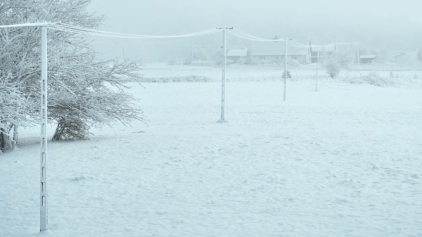 A utility pole and wires are covered with ice. Power outage during a winter snowstorm.; Shutterstock ID 2252520727; purchase_order: -; job: -; client: -; other: