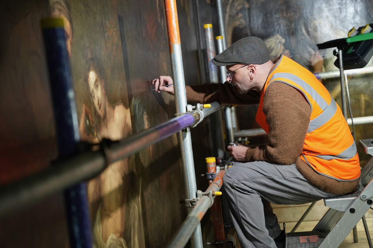 A man painting a mural