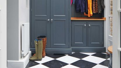 mudroom with chequered floor and closed cabinetry