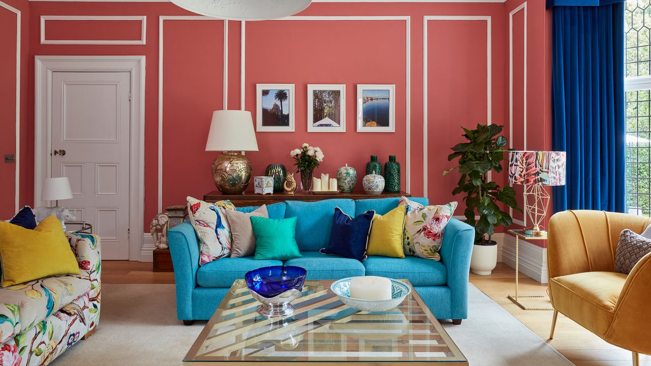 colourful living room with blue sofa and pink walls