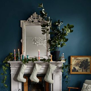 White mantlepiece on fireplace, with Christmas stockings