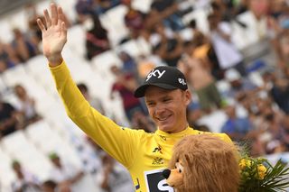 Chris Froome waves to fans after stage 20 of the Tour de France