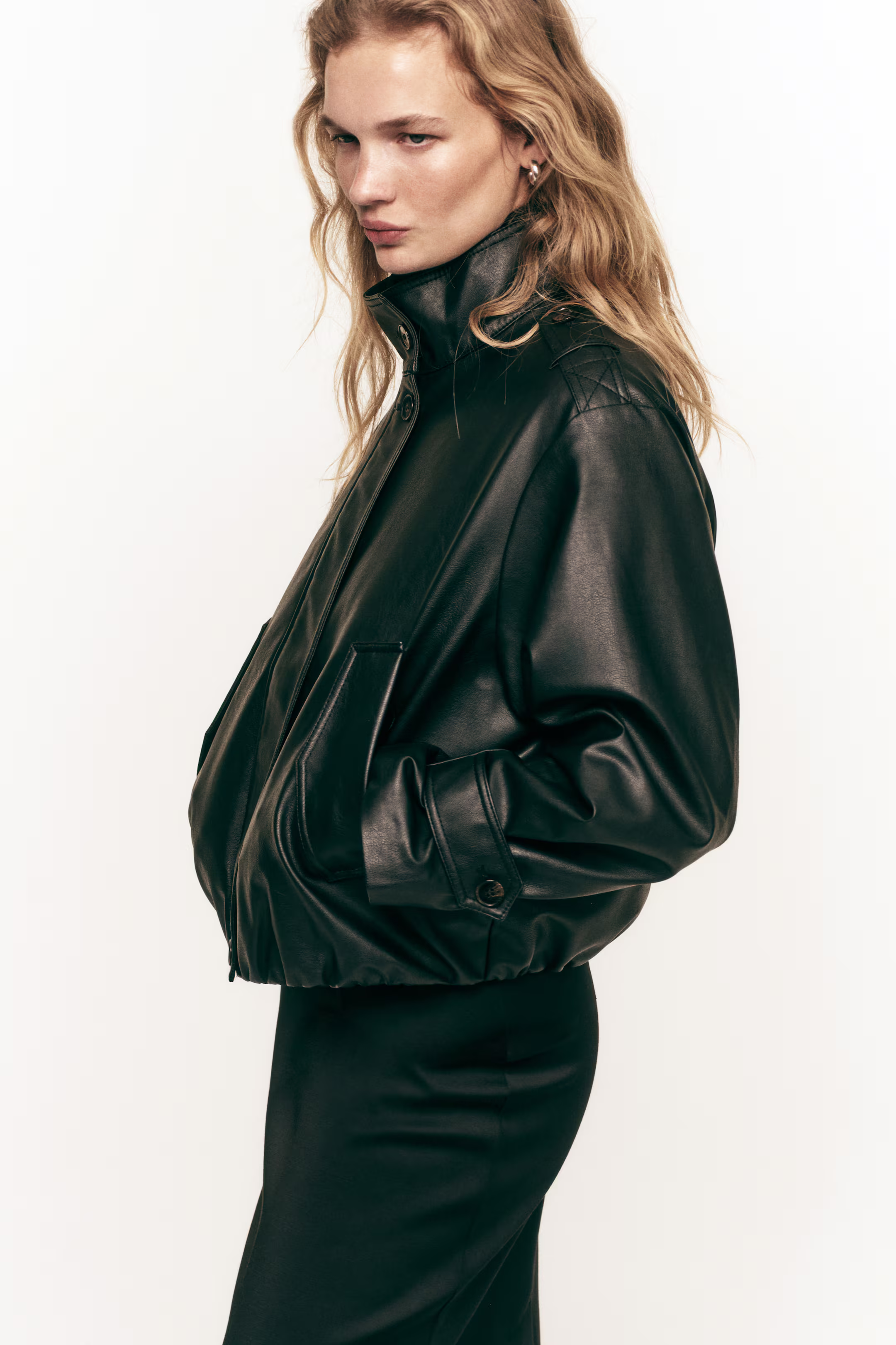 A woman wearing a black leather jacket.