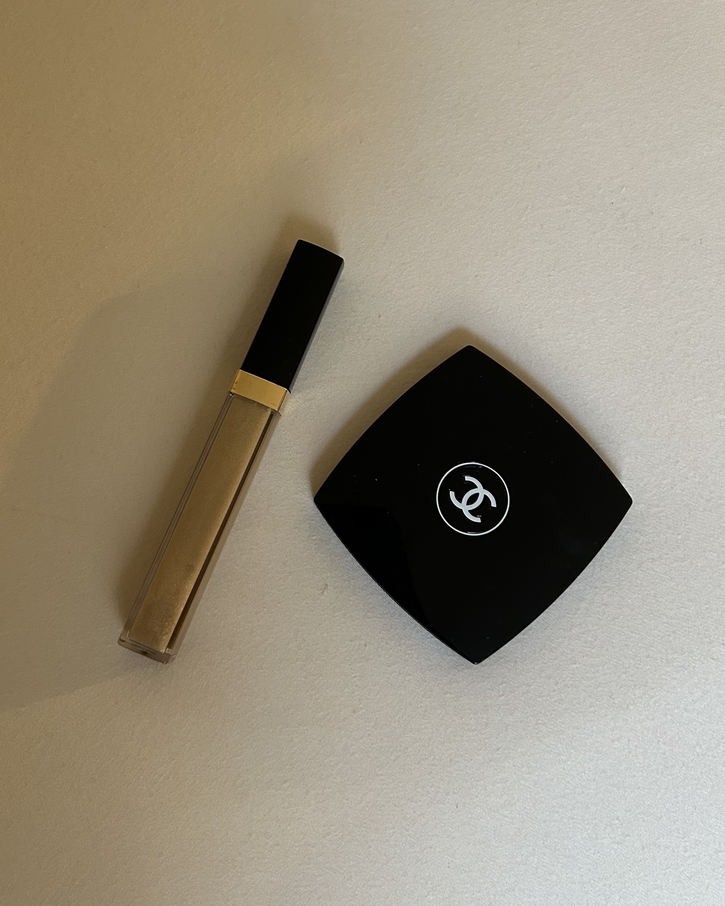 Alyssa Brascia's Chanel Rouge Coco Gloss Moisturizing Glossimer and Chanel mirror compact laying next to one another.