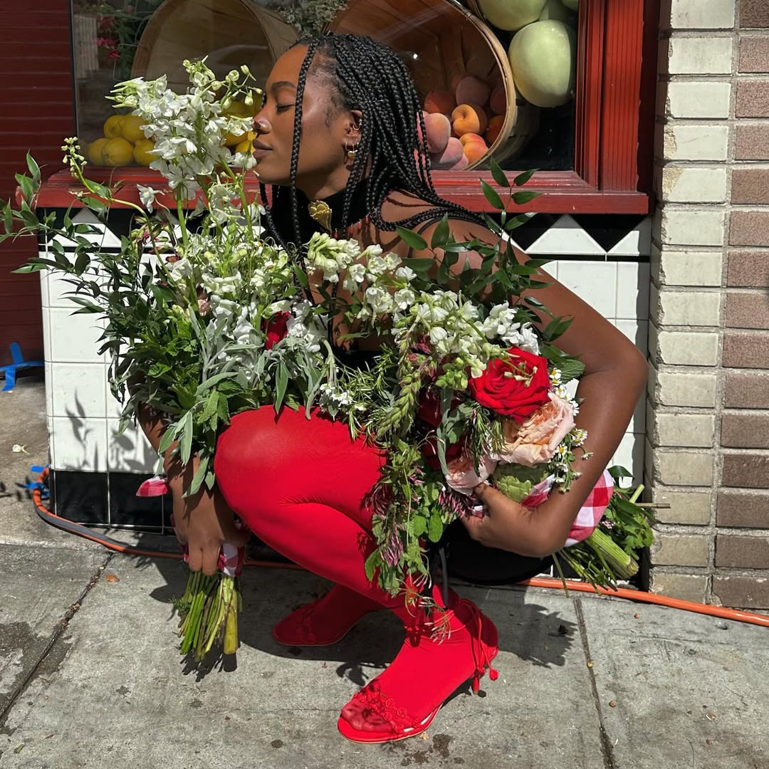 An image of content creator Gabrielle Richardson smelling florals.