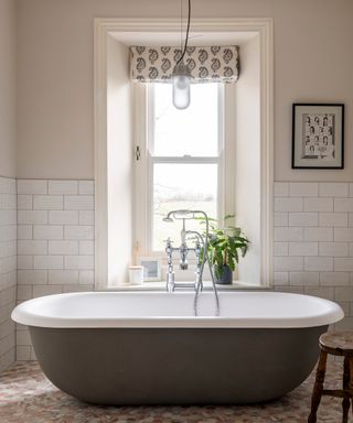 bathroom in a country house with freestanding tub and neutral decor