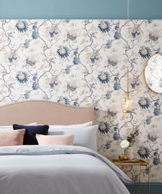 bedroom with floral wallpaper and pillows