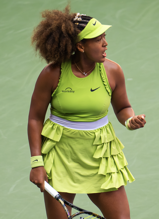 Naomi Osaka wears a brat green tennis dress with ruffles on Day 2 of the US Open at USTA Billie Jean King National Tennis Center on August 27, 2024 in New York City