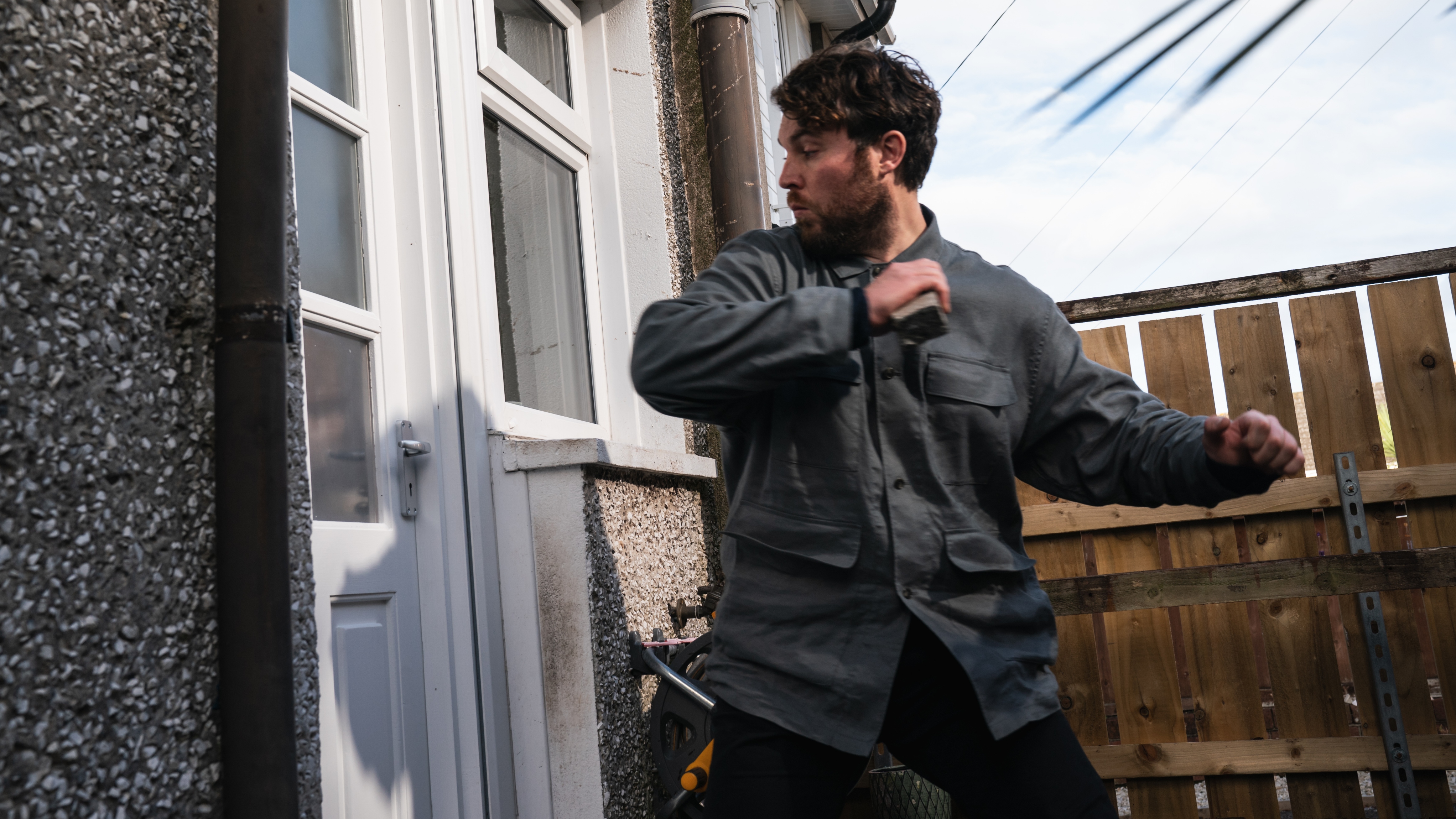 James breaks down a back door at Maria's house