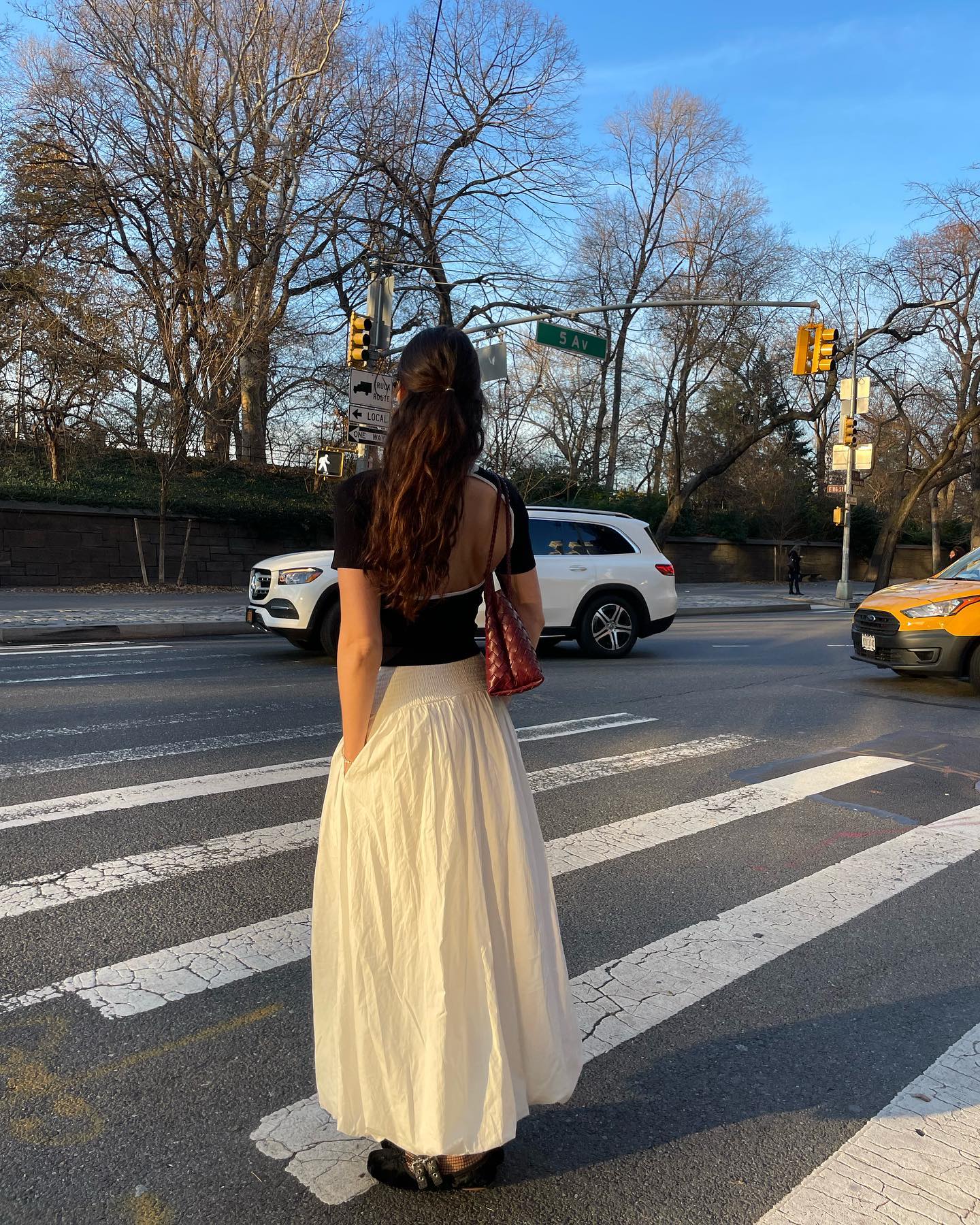Cotton Skirt Trend: @anna_laplaca wears a cream cotton skirt with a black top whilst at a street crossing