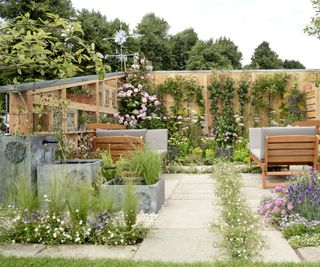 Garden designed to prevent flooding with permeable paving and water run off from roof