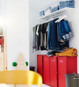 Kids room with red lockers and hanging rail