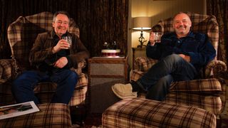 Paul Whitehouse (L) and Bob Mortimer (R) toasting the New Year in Scotland on tartan armchairs