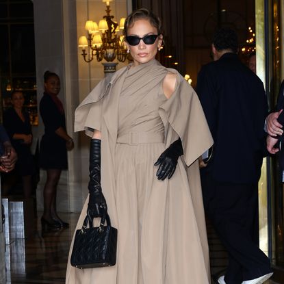 Jennifer Lopez leaves her hotel in paris wearing a khaki belted dior dress and a black lady dior bag