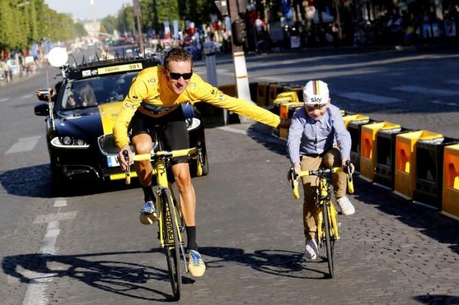 Bradley Wiggins takes a victory lap in Paris with his son after winning the 2012 Tour de France.