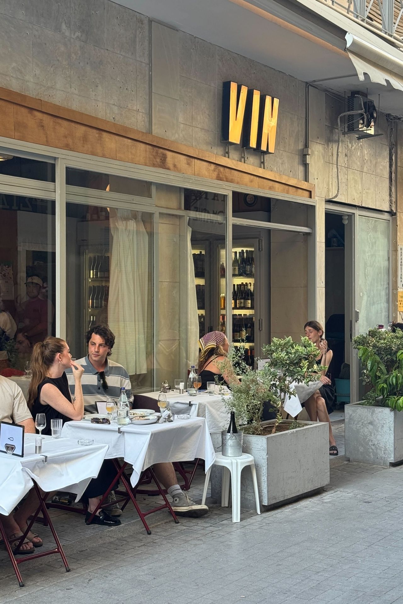 A serious of sights, restaurants, plates, and newsstands in Athens merge rough cement buildings with a contemporary vibe.