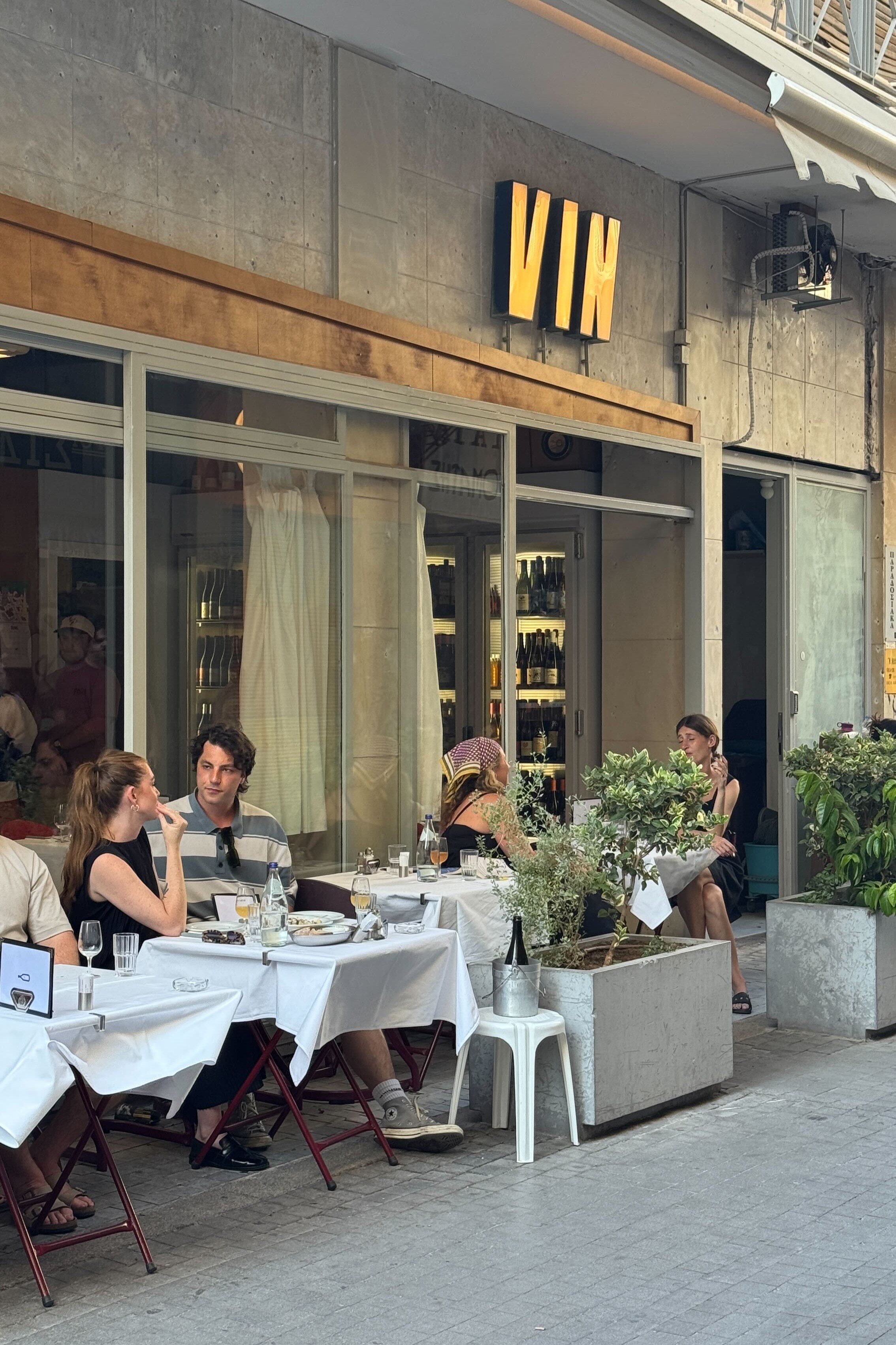 A serious of sights, restaurants, plates, and newsstands in Athens merge rough cement buildings with a contemporary vibe.