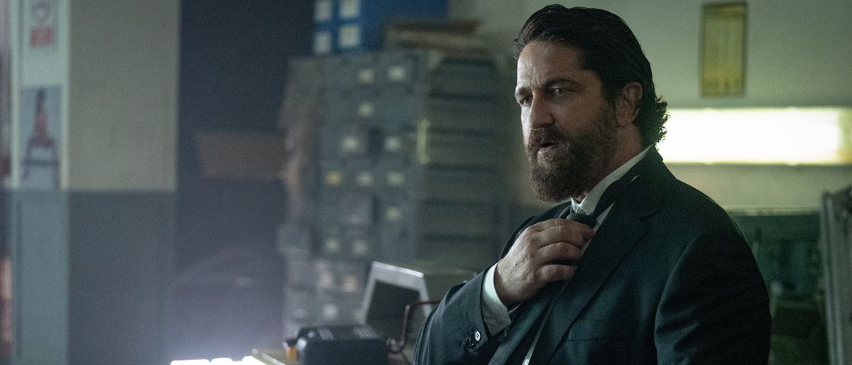 Gerard Butler wearing a suit in Den Of Thieves 2: Pantera