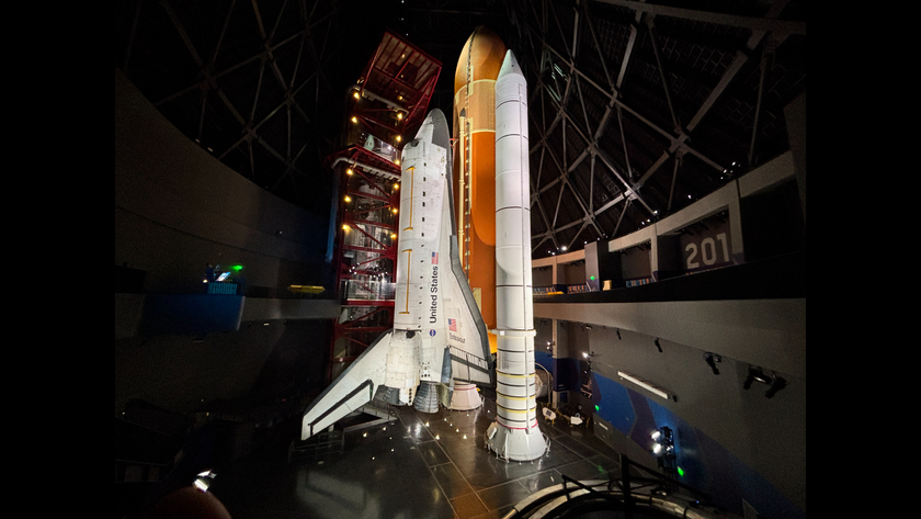 The space shuttle Endeavor stands upright in a museum. 