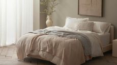 Effortless bedding ideas from Coyuchi: sheets and throws draped across a bed.