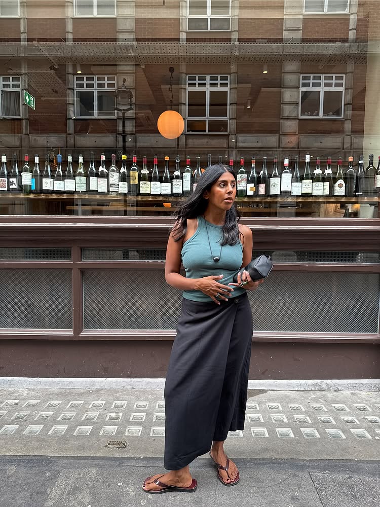 @Monikh in a turquoise vest with a black wrap linen skirt