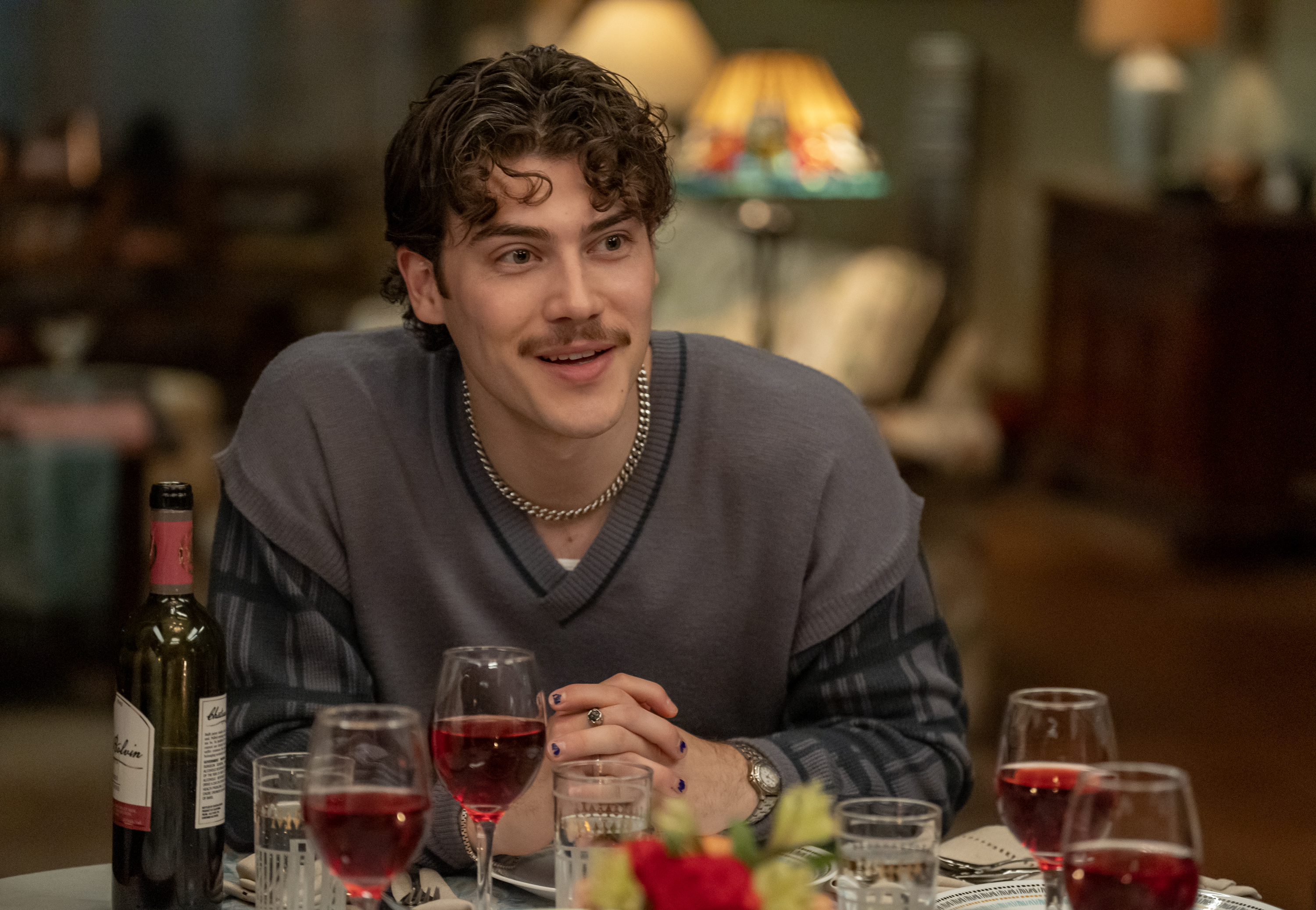 Jack Innanen as Paul Baker, sitting at a dinner table with glasses of wine, in 'Adults.'