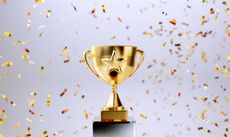 gold trophy with a star on it surrounded by confetti
