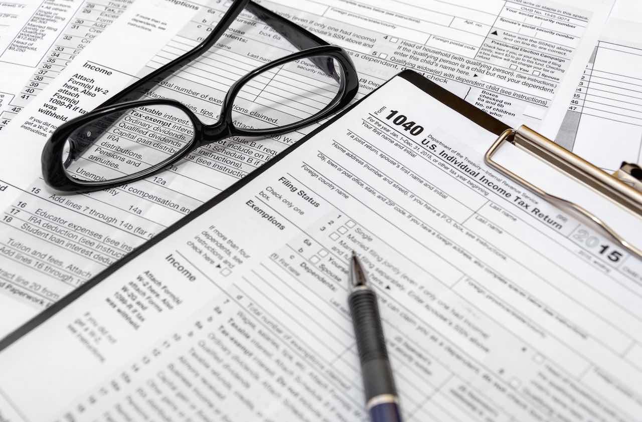 Tax form with pen and glasses