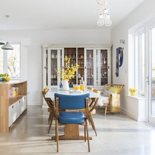 dining area with dining table and white wall