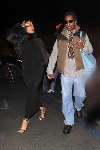 Rihanna is stylish in an all black ensemble as she and partner A$AP Rocky attend a party at Hind in West Hollywood. She wore a black dress and leather duster coat with a black alaia shoulder bag