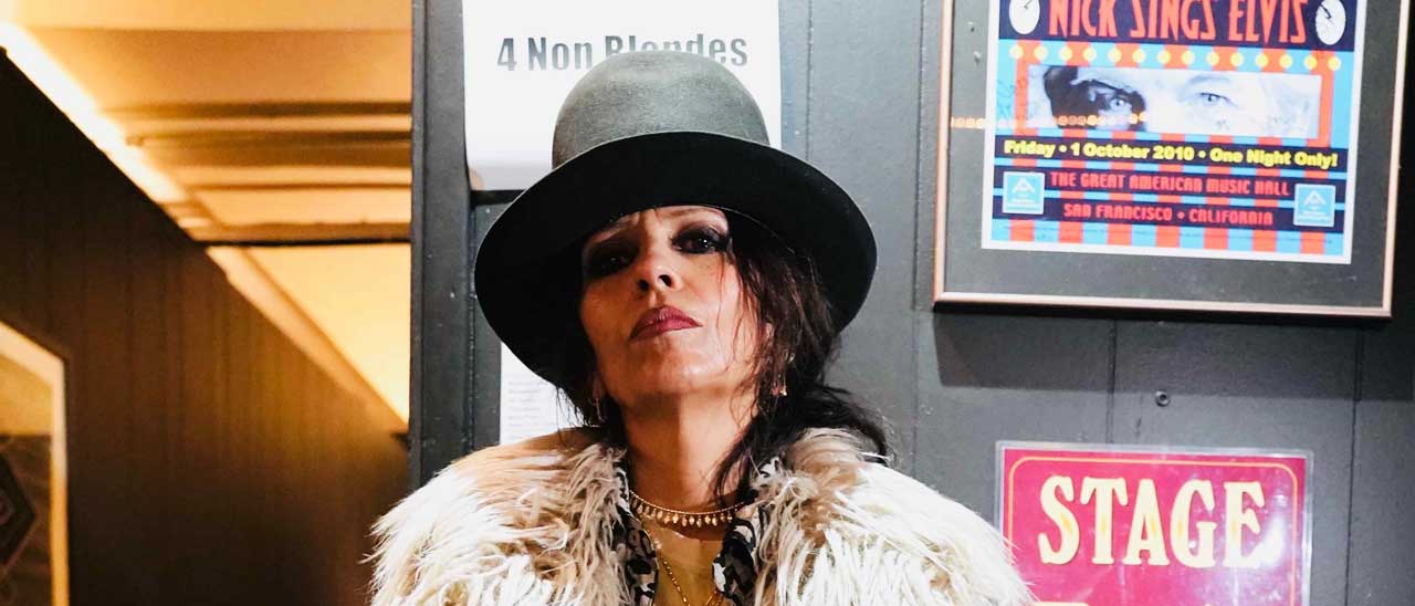 Linda Perry standing backstage