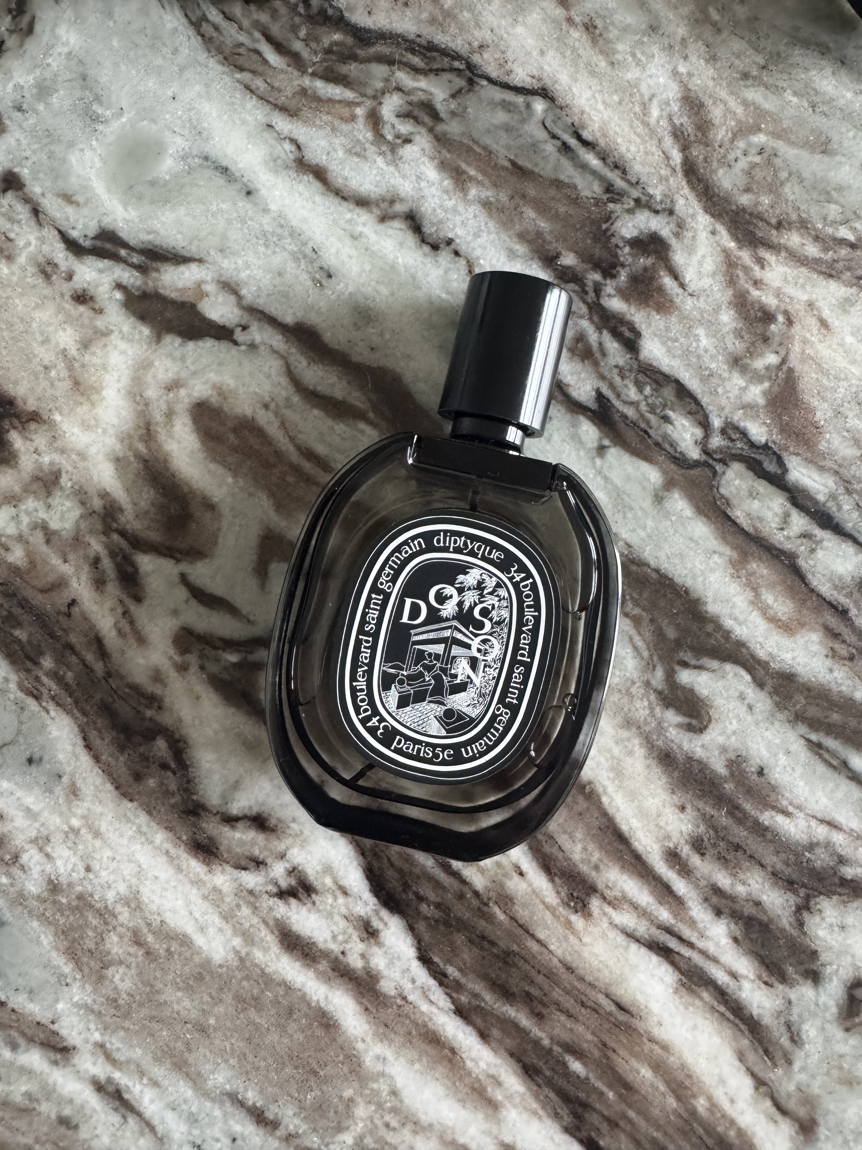 A bottle of Diptyque Do Son on a marble table