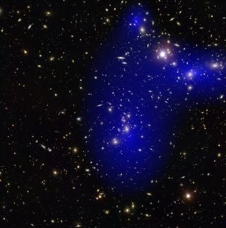 The galaxy cluster Abell 2744 is seen with a dark matter map overlay (in blue).