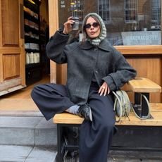 @tia_dewitt wears navy trousers grey coat