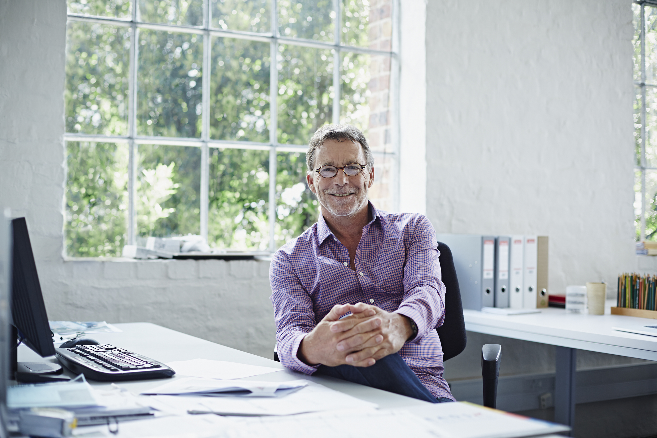 Portrait of relaxed business man in modern office
