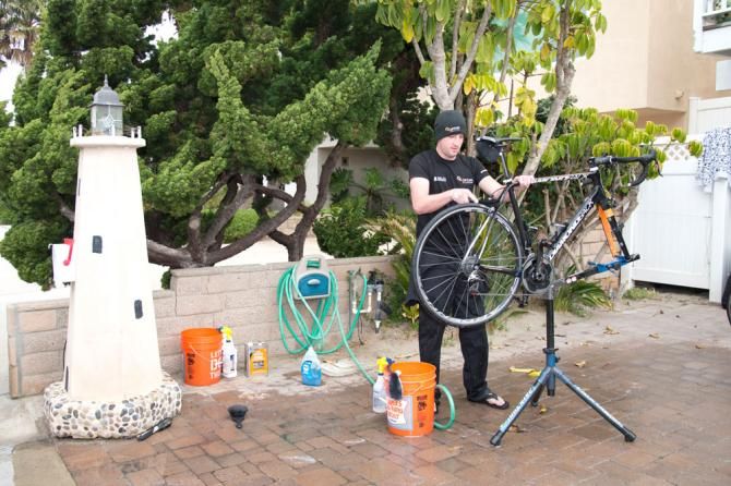The beach environment in Oxnard makes for a nice day of washing bikes for mechanic Evan Mumford.