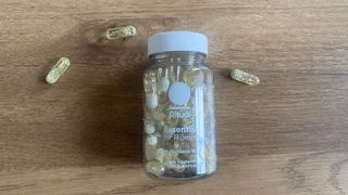 Ritual Essential for Women Multivitamin capsules and container on a table