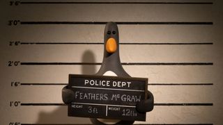 Feathers McGraw holding up a police sign during a mugshot in the trailer for the new movie, Wallace and Gromit: Vengeance Most Fowl.