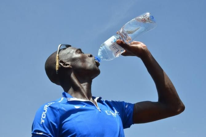 Tour du Faso stage 1 winner Issaka Kabre rehydrates.